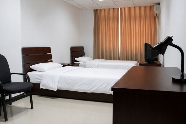 Hubei Minzu University international student hostel room, twin-share accommodation.
